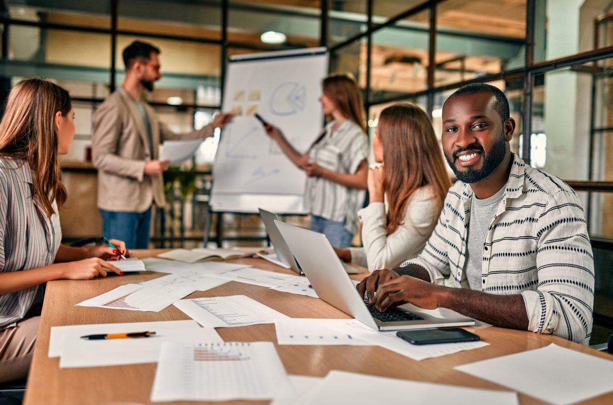 Smiling professional in a team meeting around a conference table