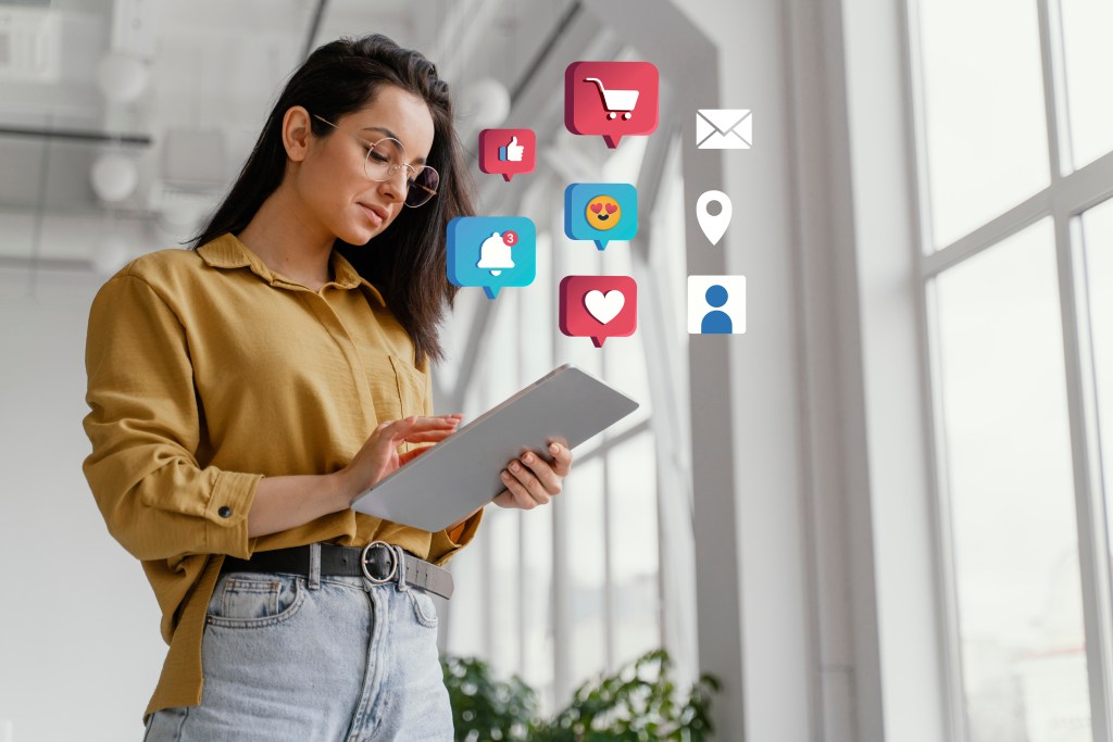 Woman using tablet with digital icons representing omni-channel customer experience strategy